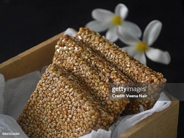 close-up of sesame brittle/chikki in a wooden box - pongal stock pictures, royalty-free photos & images