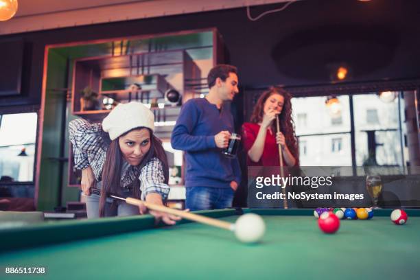 friends having a fun while playing billiard in a pub. - snooker break stock pictures, royalty-free photos & images