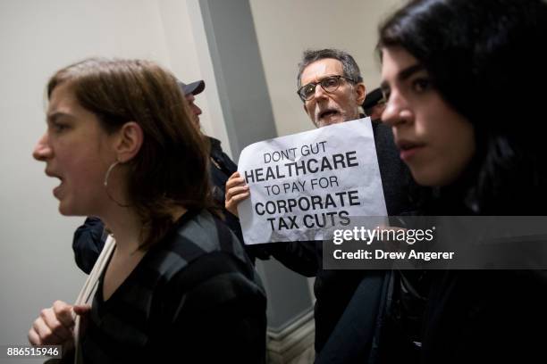 Activists rally against the GOP tax reform bill outside the office of Rep. Claudia Tenney on Capitol Hill, December 5, 2017 in Washington, DC. The...