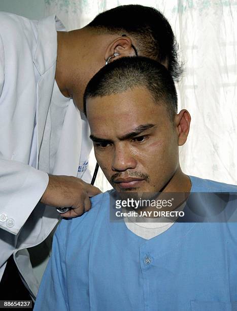 Assar Bernardino Venancio is treated by a doctor in a Philippine military hospital in Taguig, suburban Manila on June 24, 2009. Venancio is a...