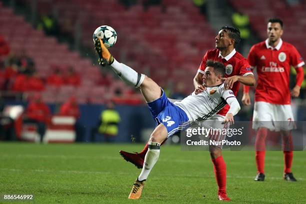 Basel's midfielder Taulant Xhaka from Albania fights for the ball with Benfica's Portuguese midfielder Joao Carvalho during the UEFA Champions League...