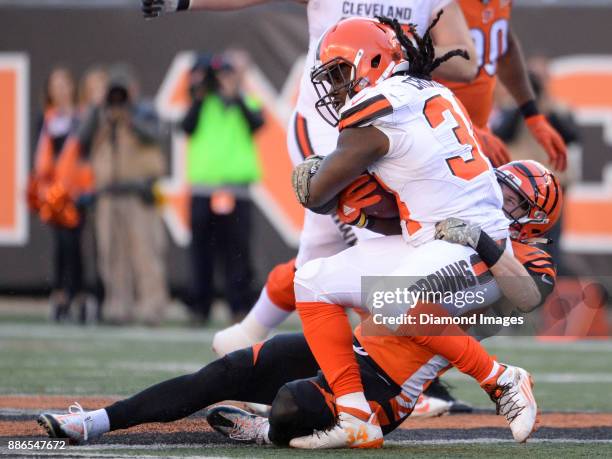 Running back Isaiah Crowell of the Cleveland Browns is tackled by safety Clayton Fejedelem of the Cincinnati Bengals in the third quarter of a game...