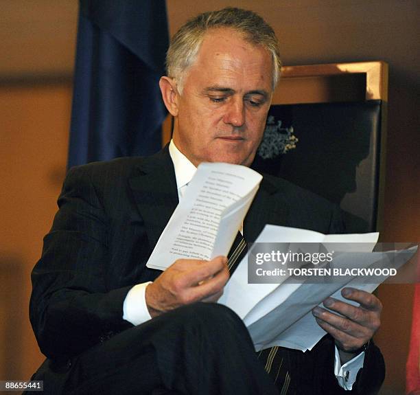 Australian opposition leader Malcolm Turnbull checks his notes during an official reception at Parliament House in Canberra on June 24, 2009....