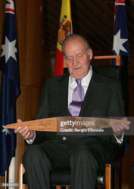 King Juan Carlos I, inspects a indigenous message stick during a reception at Parliament House, as part of their 3 day State visit to Australia on...