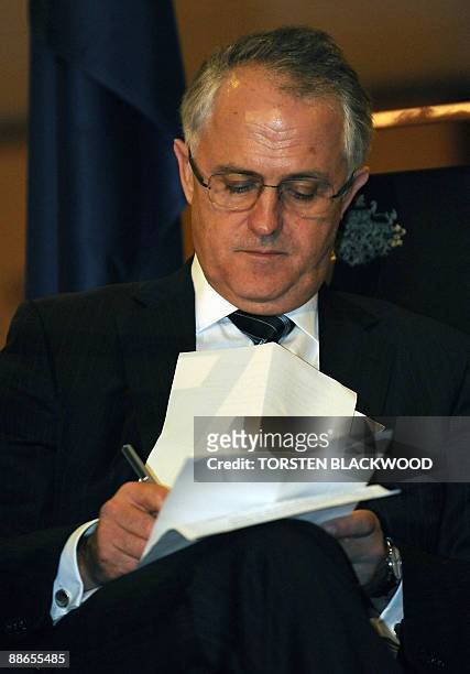 Australian opposition leader Malcolm Turnbull checks his notes during an official reception at Parliament House in Canberra on June 24, 2009....