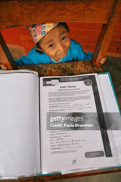 Khagendra Thapa Magar, 15 and a half, shows off his application to the Guinness Book of World Records filed by his manager Min Bahadur Rana Magar on...