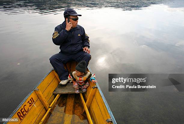 Khagendra Thapa Magar, 15 and a half, goes on a boat ride on Fewa Lake with his manager Min Bahadur Rana Magar on March 13, 2007 in Pokhara, Nepal....