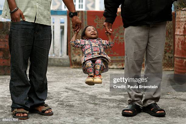 Khagendra Thapa Magar, 15 and a half, holds hands with family friends March 12, 2007 in Pokhara, Nepal. According to the Guinness World Book of...