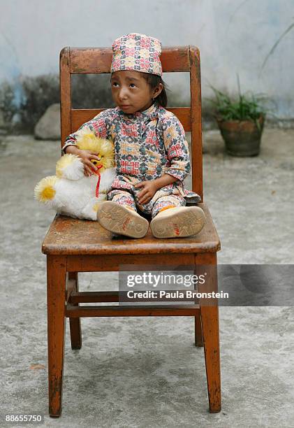 Khagendra Thapa Magar, 15 and a half, plays with some of his toys outside his house March 12, 2007 in Pokhara, Nepal. According to the Guinness World...