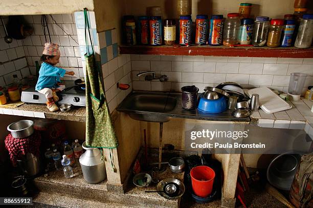 Khagendra Thapa Magar, 15 and a half, cooks some eggs in the kitchen at his home on March 13, 2007 in Pokhara, Nepal. According to the Guinness World...
