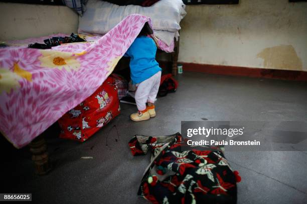 Khagendra Thapa Magar, 15 and a half, looks for some clothes under his bed on March 13, 2007 in Pokhara, Nepal. According to the Guinness World Book...