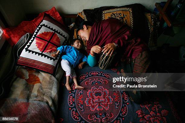 Khagendra Thapa Magar, 15 and a half, shares a warm moment relaxing with Dhan Kumari who is his manager's wife, acting as his second mother on March...