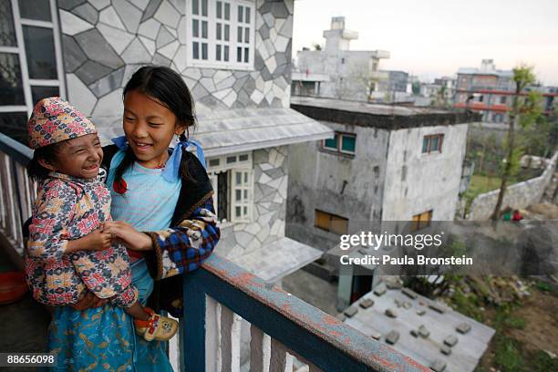 Khagendra Thapa Magar, 15 and a half, enjoys some time with family friend Sabina,11 on March 13, 2007 in Pokhara, Nepal. According to the Guinness...