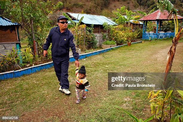 Khagendra Thapa Magar, 15 and a half, goes on a walk to Fewa Lake with his manager Min Bahadur Rana Magar on March 13, 2007 in Pokhara, Nepal....