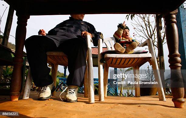 Khagendra Thapa Magar, 15 and a half, enjoys an afternoon at Fewa Lake at a restaurant with his manager Min Bahadur Rana Magar on March 13, 2007 in...