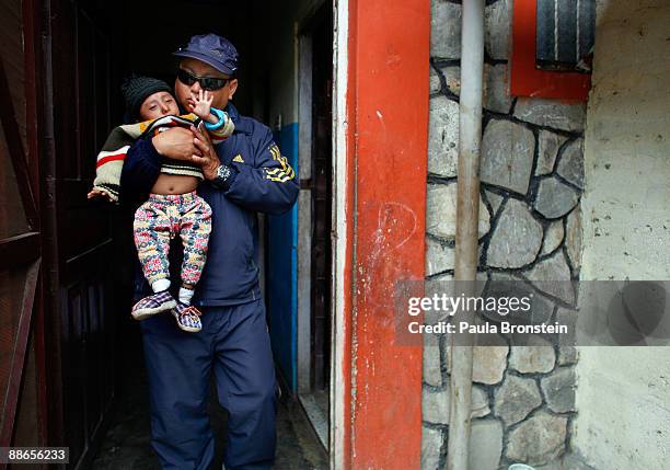 Khagendra Thapa Magar, 15 and a half, gets carried out of their home by his manager Min Bahadur Rana Magar on March 13, 2007 in Pokhara, Nepal....
