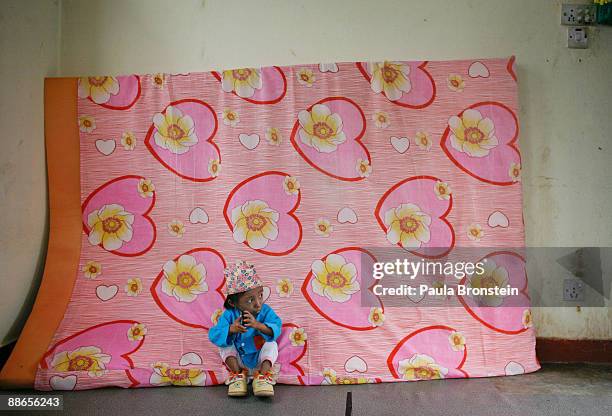 Khagendra Thapa Magar, 15 and a half, hangs out in his bedroom, sitting against a mattress on March 12, 2007 in Pokhara, Nepal. According to the...