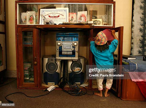 Khagendra Thapa Magar, 15 and a half, looks inside the stereo cabinet on March 12, 2007 in Pokhara, Nepal. According to the Guinness World Book of...