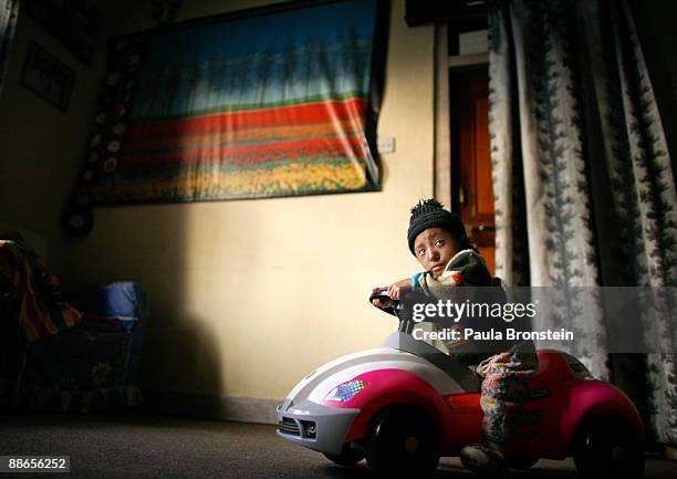 Khagendra Thapa Magar, 15 and a half, sits on his toy car at home on March 12, 2007 in Pokhara, Nepal. According to the Guinness World Book of...