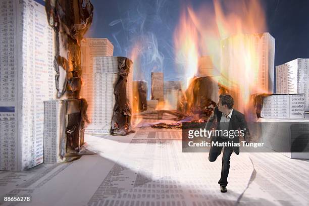business man ecsaping from burning city - fire escape fotografías e imágenes de stock