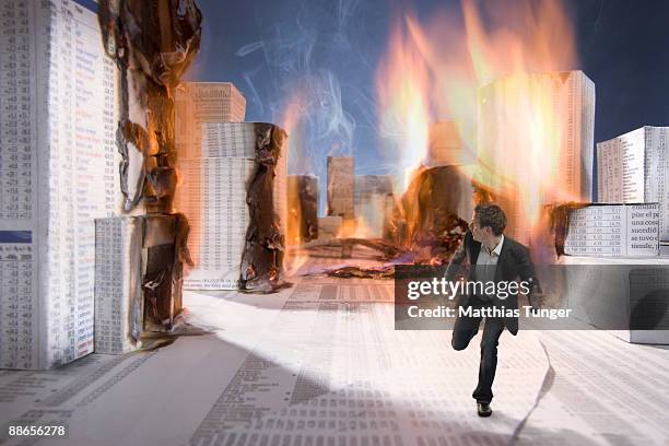 business man ecsaping from burning city - evasion fiscale stockfoto's en -beelden