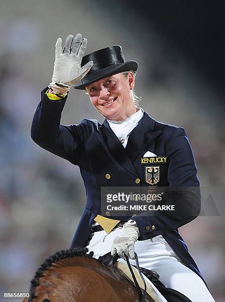 Picture taken on August 16, 2008 in Hong Kong shows Germany's rider Isabell Werth on "Satchmo" waving after competing in the dressage individual...