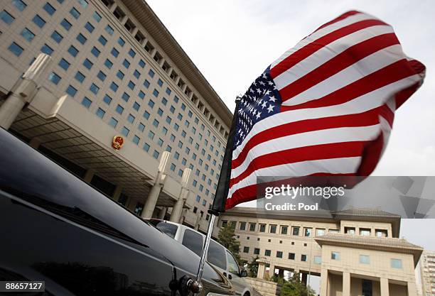 The United States flag flies from an embassy car outside China's Ministry of Defense while U.S. Department of Defense Under Secretary Michele...