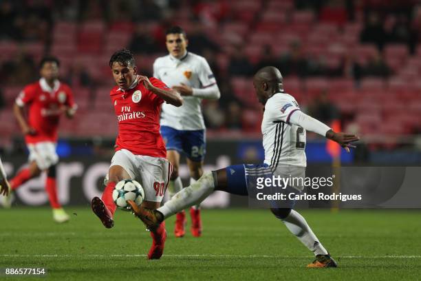 Benfica's midfielder Joao Carvalho from Portugal vies with Fc Basel defender Eder Balanta from Colombia for the ball possession during SL Benfica v...