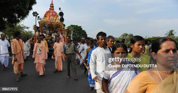 Indian devotees and members of the International Society for Krishna Consciousness pull a chariot carrying a deity during the annual Rath Yatra...