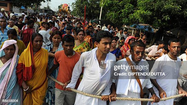 Indian devotees and members of the International Society for Krishna Consciousness pull a chariot carrying a deity during the annual Rath Yatra...