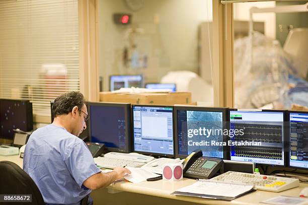 surgeon studies patient notes - glendale california stock pictures, royalty-free photos & images