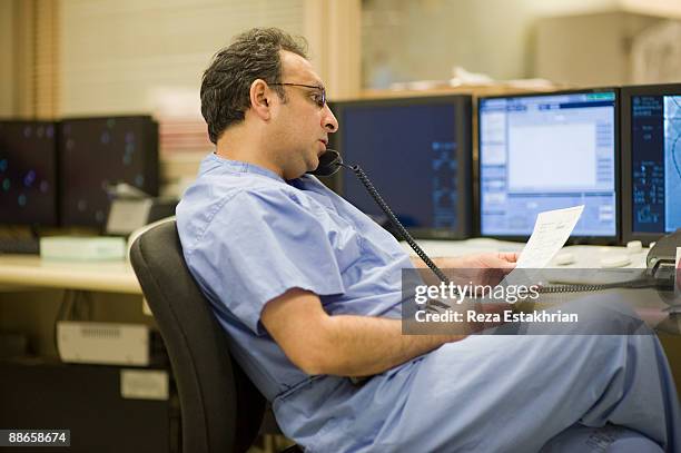 surgeon talks on phone - glendale california stock pictures, royalty-free photos & images
