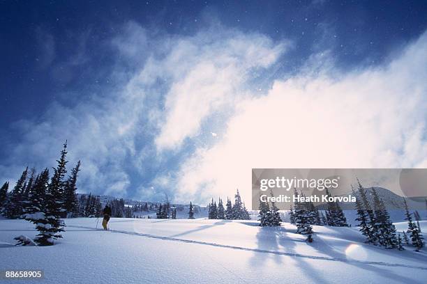 solo backcountry skier ascending a snowy slope. - nelson british columbia stock pictures, royalty-free photos & images