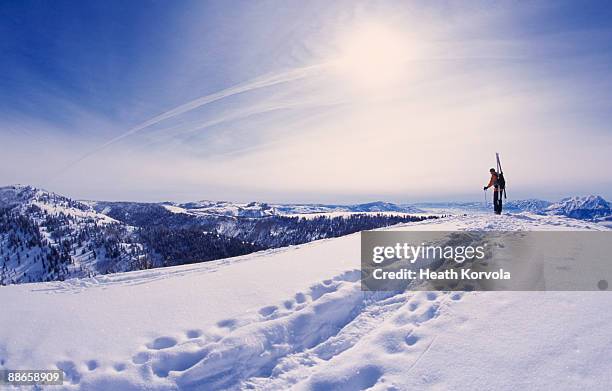 man hiking with skis through snow in mountains. - park city stockfoto's en -beelden