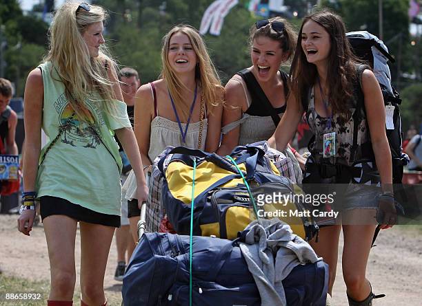 Romy Somerset, Bella Dorey, Miranda Marsh, and Tina Oundjian laugh as they arrive at the Glastonbury Festival site at Worthy Farm, Pilton on June 24,...
