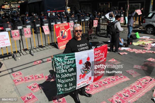 Portrait of a young activist injured during the protest against a law that militarizes crime fighting in the country outside the Senate, Mexico City,...