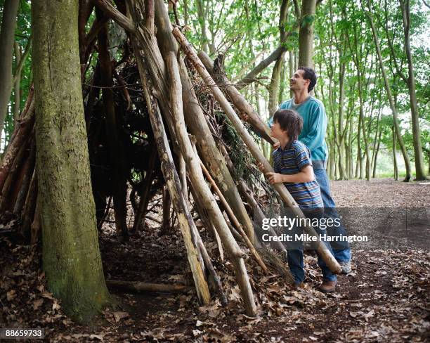 young boy and father in forest. - teepee stock pictures, royalty-free photos & images