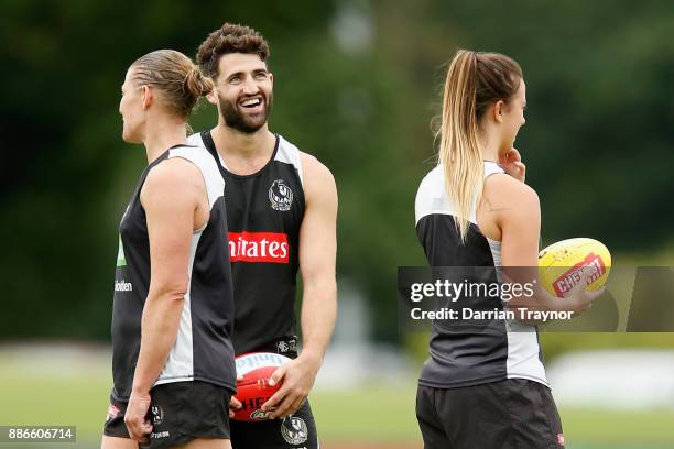 Alex Fasolo shares a laugh with Meg Hutchins during a Collingwood Magpies men's and women's joint AFL pre-season training session at the Holden...