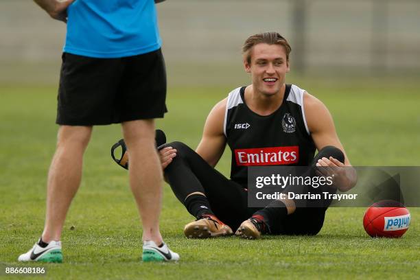 Darcy Moore of the Magpies stretches before a Collingwood Magpies men's and women's joint AFL pre-season training session at the Holden Centre on...