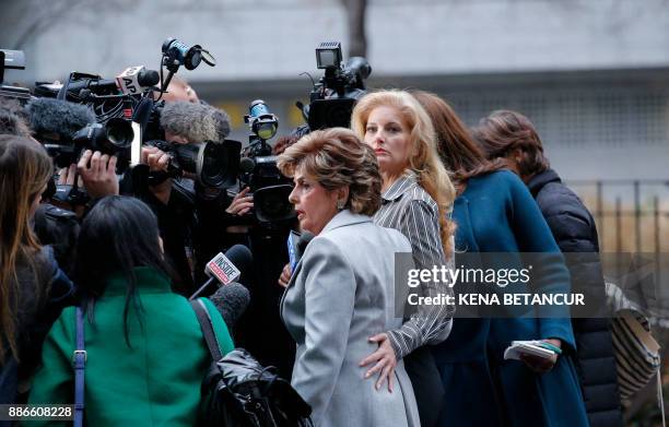 Summer Zervos a former contestant on "The Apprentice" looks at the camera as she embraces lawyer Gloria Allred after they leave the New York County...