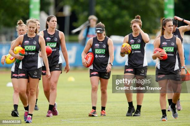 Players warm up before a Collingwood Magpies men's and women's joint AFL pre-season training session at the Holden Centre on December 6, 2017 in...