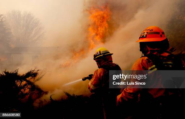 Firefighters battle the Creek Fire as it burns near a church along Foothill Boulevard in Sylmar on Tuesday, Dec. 5, 2017. The fire started at about...