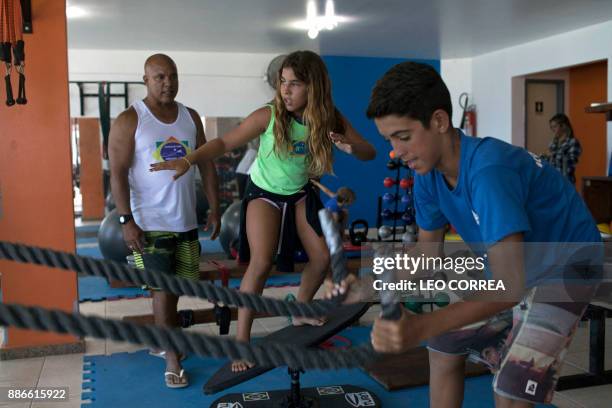 Surfing teacher Luiz Augusto de Matos conducts a training session at the "Inside Fit" surf training centre in Saquarema, Rio de Janeiro state, Brazil...