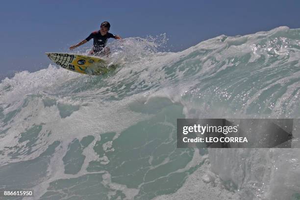 Young surfer Rickson Falcao rides a wave at Saquarema's beach in Rio de Janeiro state, Brazil, on November 29, 2017. Despite its vast Atlantic...