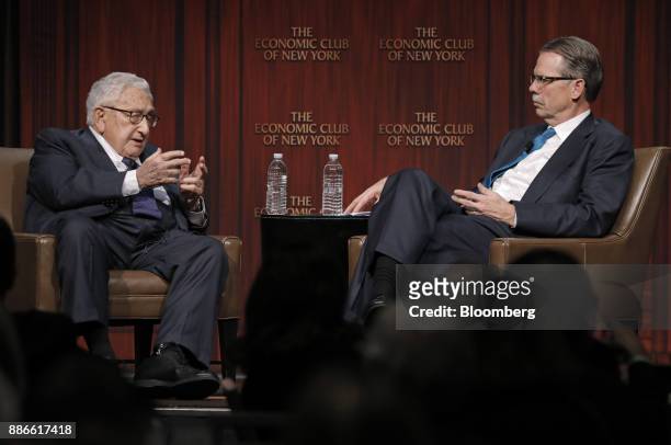 Henry Kissinger, left, former U.S. Secretary of state, speaks with Glenn Hutchins, co-founder of Silver Lake Credit Fund LP, during an Economic Club...