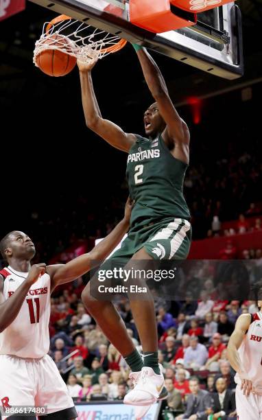 Jaren Jackson Jr. #2 of the Michigan State Spartans dunks the ball in the second half as Eugene Omoruyi of the Rutgers Scarlet Knights defends on...