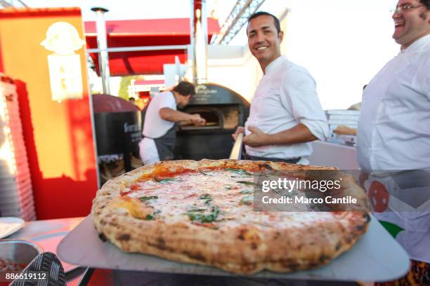 The pizza master, Gino Sorbillo, prepares a pizza on the Caracciolo seafront in Naples.