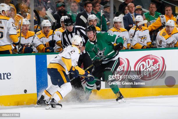 Brett Ritchie of the Dallas Stars handles the puck against Anthony Bitetto of the Nashville Predators at the American Airlines Center on December 5,...