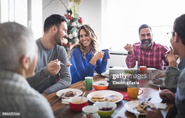 family having breakfast on christmas morning. - christmas coffee stock pictures, royalty-free photos & images