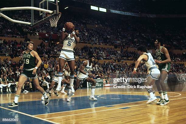 Jim McMillian of the Buffalo Braves rebounds against the Bosoton Celtincs during a game played in 1974 at the Buffalo Memorial Auditorium in Buffalo,...